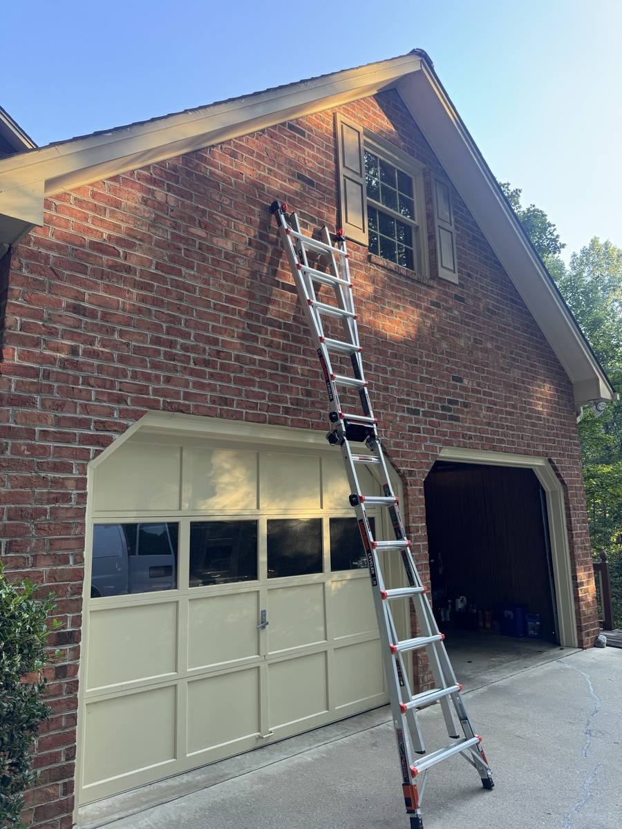 Ladder set to a brick gable for bat exclusion work in Lenoir NC